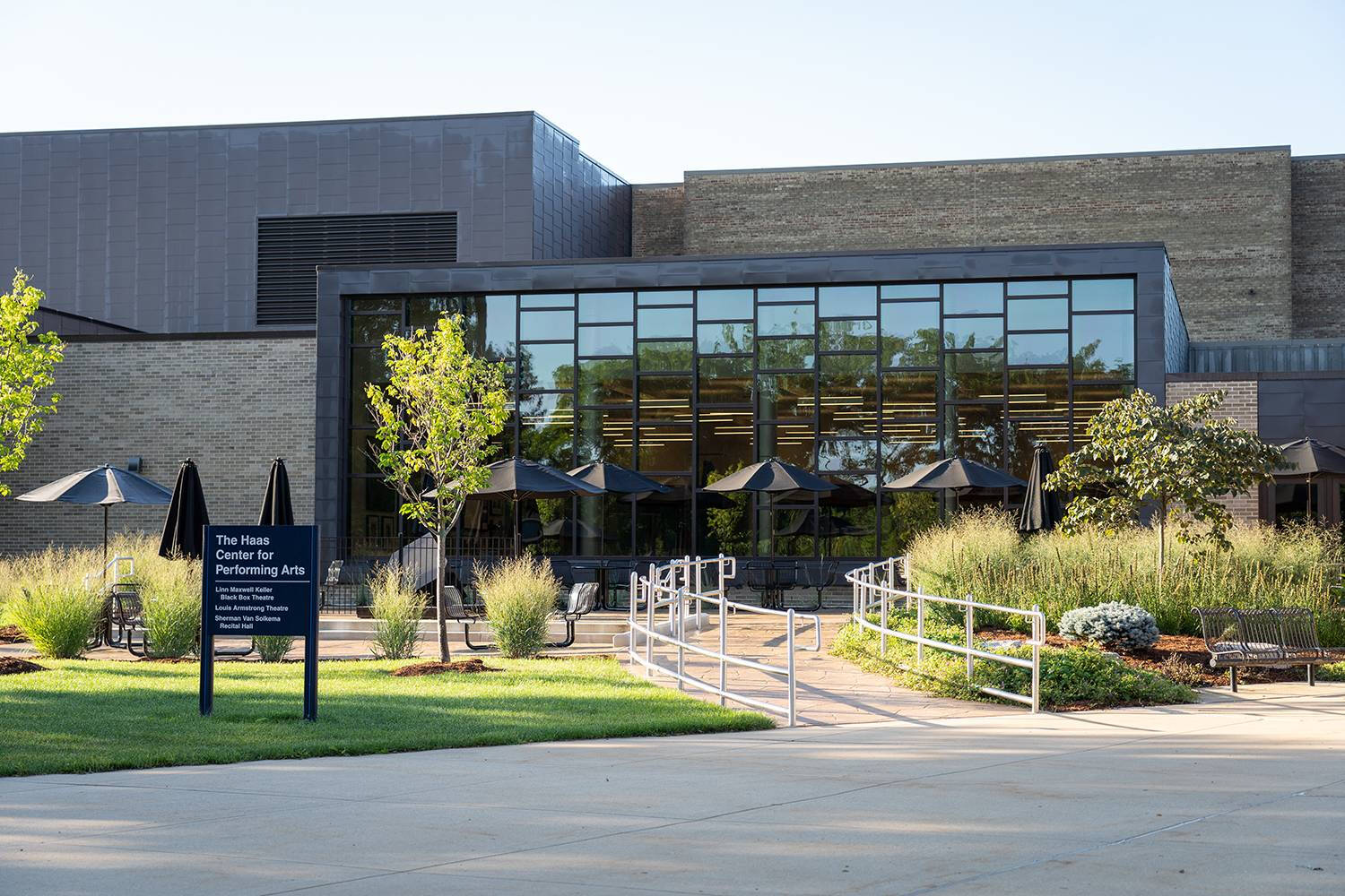 Photograph of the exterior of a brick and glass building.